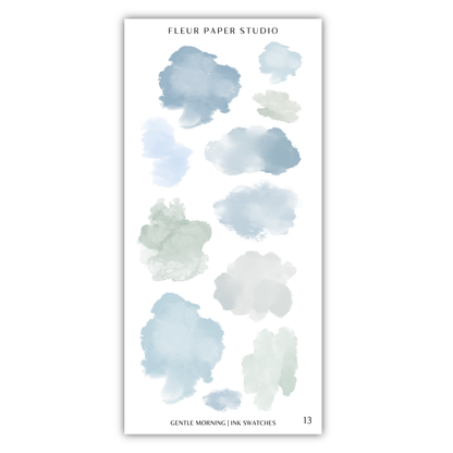 a collection of abstract watercolor brush strokes in various shades of blue and gray, arranged in a grid-like pattern.