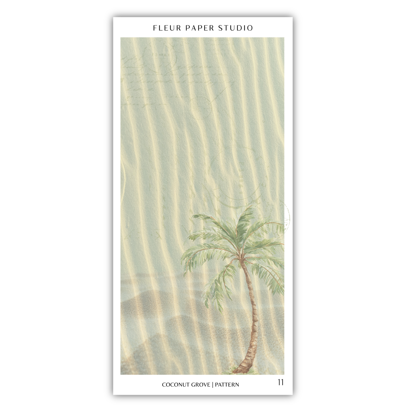 A palm tree with green leaves stands in the sand, creating a serene and tropical scene.