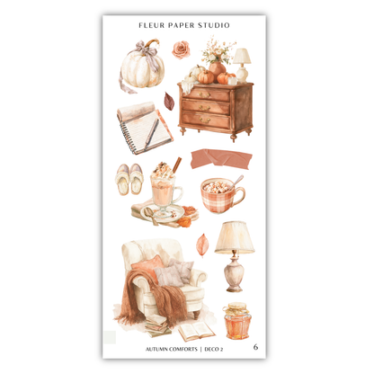 various objects and items related to autumn, such as a pumpkin, a desk, a lamp, a cup, a book, a chair, and a vase.